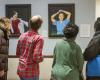 People viewing Chen paintings in the dean's office 