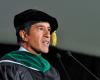 Photo of Sanjay Gupta in cap and gown delivering keynote address.