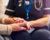 Stock image of caregiver with older patient - hands only