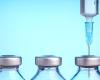 Image of 3 vaccine bottles & a syringe 