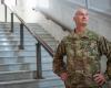 Bain wearing military uniform standing on marble steps with hands on hips