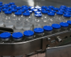 Production line of unlabeled vaccine bottles