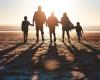 Silhouette of a family going for a walk together along the beach