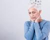 Photo of a distressed woman with short gray hair with illustration puzzle pieces flying out of the top of her head