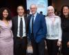 Photo of 4 students and former student with Dean Daley, all smiling at the camera