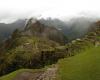 panorama of Machu Picchu site beneath cloudy skies