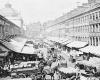 An antique black and white photo of the carts and stalls at Boston's Quincy Market from the 19th century. 