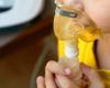 close up of child's face making an inhalation with a nebulizer