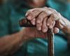 close up photo of a senior man's hands on a cane