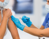 A person administers a COVID vaccine