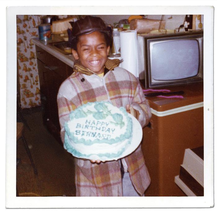smiling child holding birthday cake