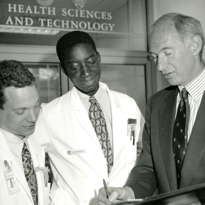 Michael Rosenblatt talks with two medical students, circa 1990s