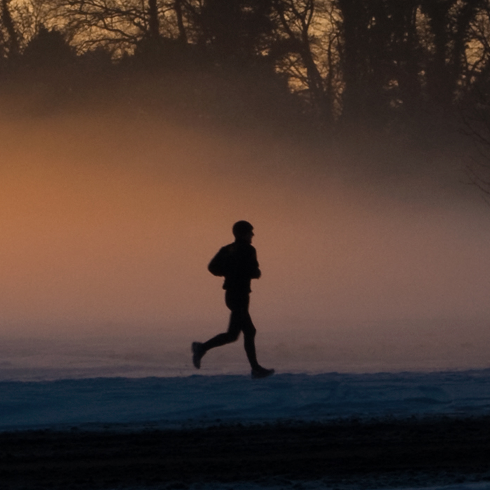 person jogging, early morning sunlight