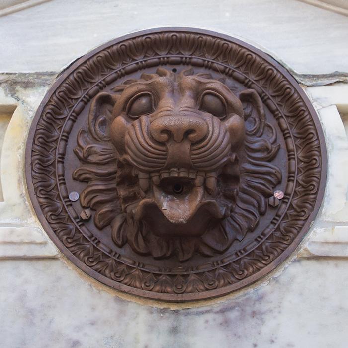lion medallion in wall surrounding the Quad