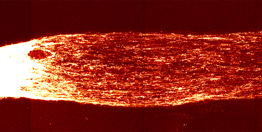 Fiery-looking bundle of nerves is white on the left side and orange-red on the right side against a black ground