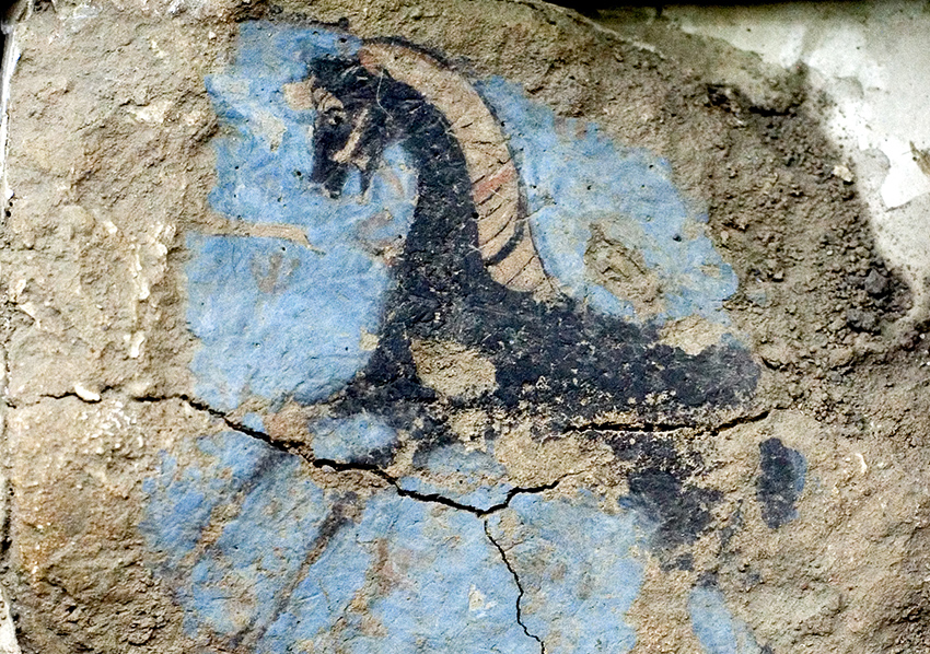 flaking and cracked fresco nonetheless shows a colorful and well-painted image of a horse shown from the side