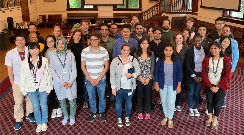 Group of diverse young people posing for photo in a meeting room