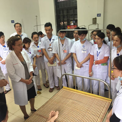 Nora Osman, left, talking to medical students in clinic in Vietnam.