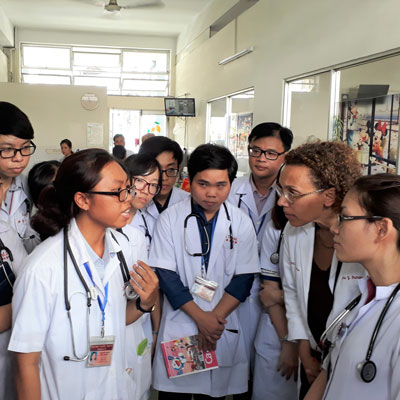Medical students on rounds in Vietnam hospital. Dr. Nora Osman, associate professor of medicine at Brigham and Women's Hospital, is second from right. 