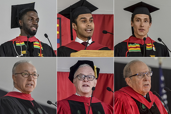 Several people wearing red and black academic regalia