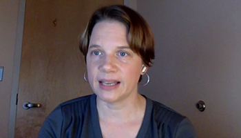 Head shot of woman with short hair speaking