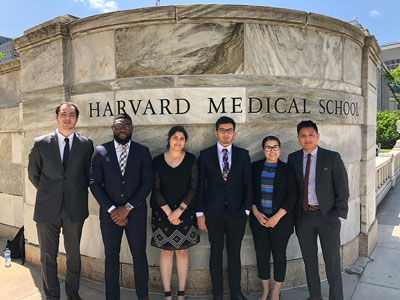 El-Baedi (center) at HMS with 2019 VRIP medical students