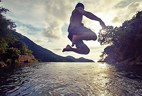 Will Chan jumping into a body of water that seemingly ends at a cliff